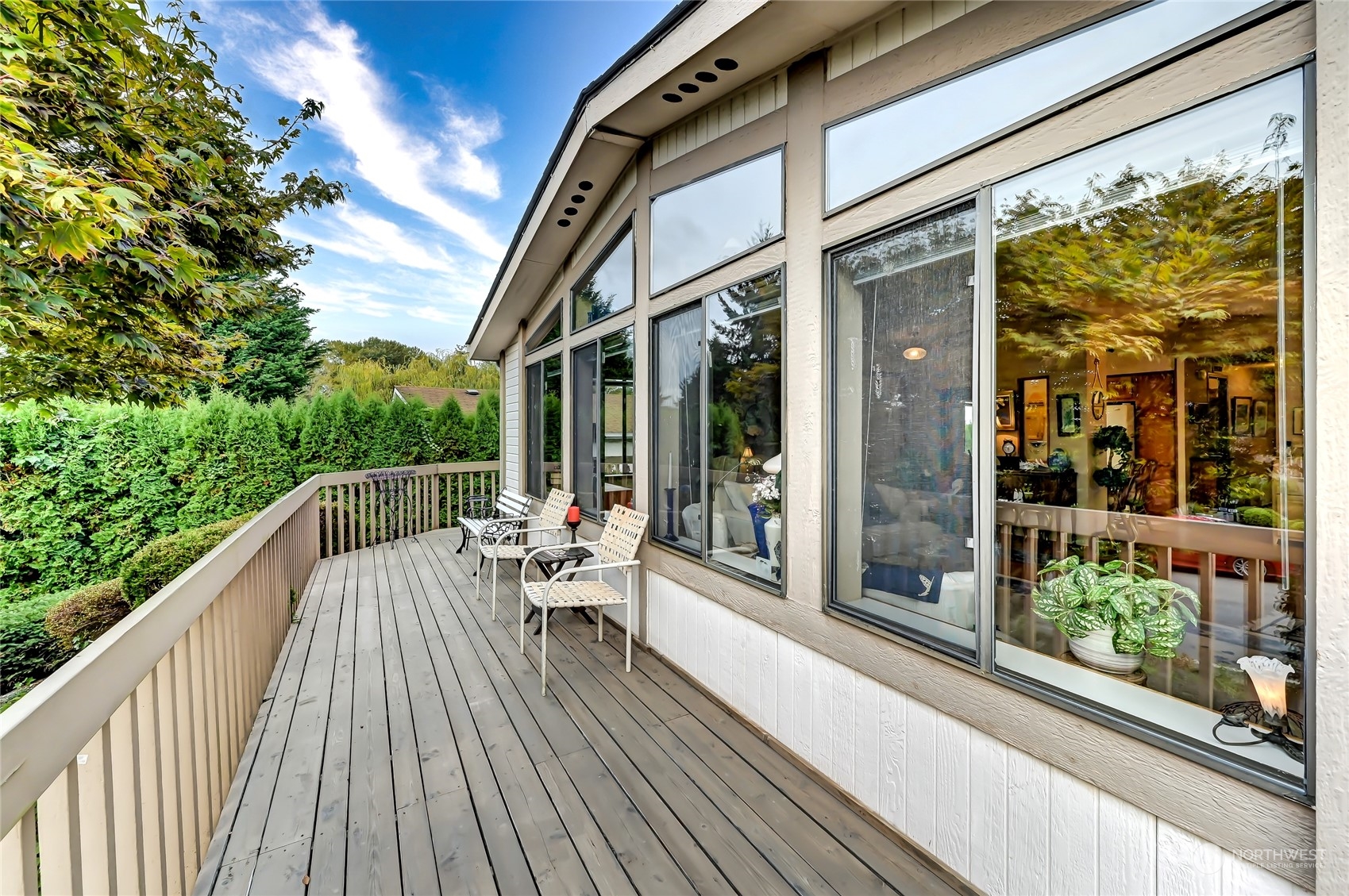 805 236th Place Southwest Bothell, WA 98021 - Photo 3 of 31 a balcony with wooden floor and outdoor seating