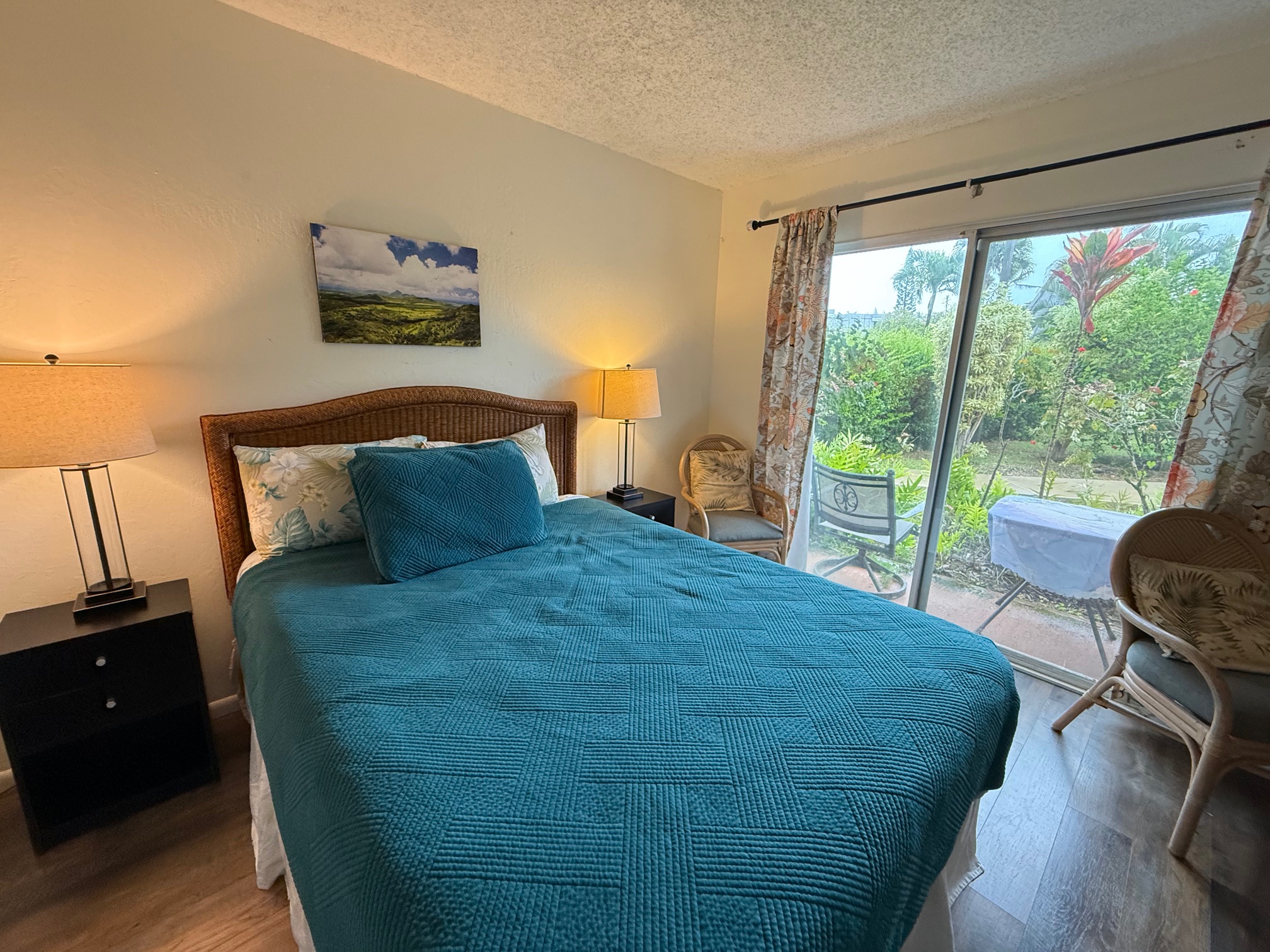 3880 Wyllie Road, Unit 8C Princeville, HI 96722 - Photo 13 of 18 a bedroom with a bed and a large window