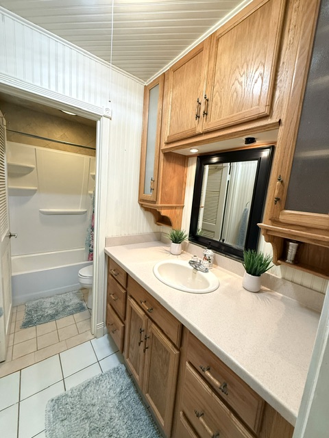 3880 Wyllie Road, Unit 8C Princeville, HI 96722 - Photo 15 of 18 a bathroom with a granite countertop sink and a mirror