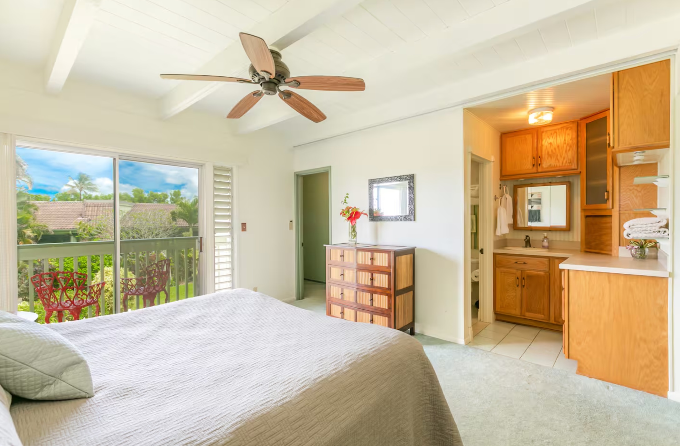3880 Wyllie Road, Unit 8C Princeville, HI 96722 - Photo 8 of 18 a bedroom with a bed dresser and a large window