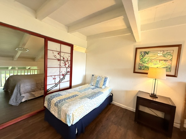 3880 Wyllie Road, Unit 8C Princeville, HI 96722 - Photo 10 of 18 a bedroom with a bed and window