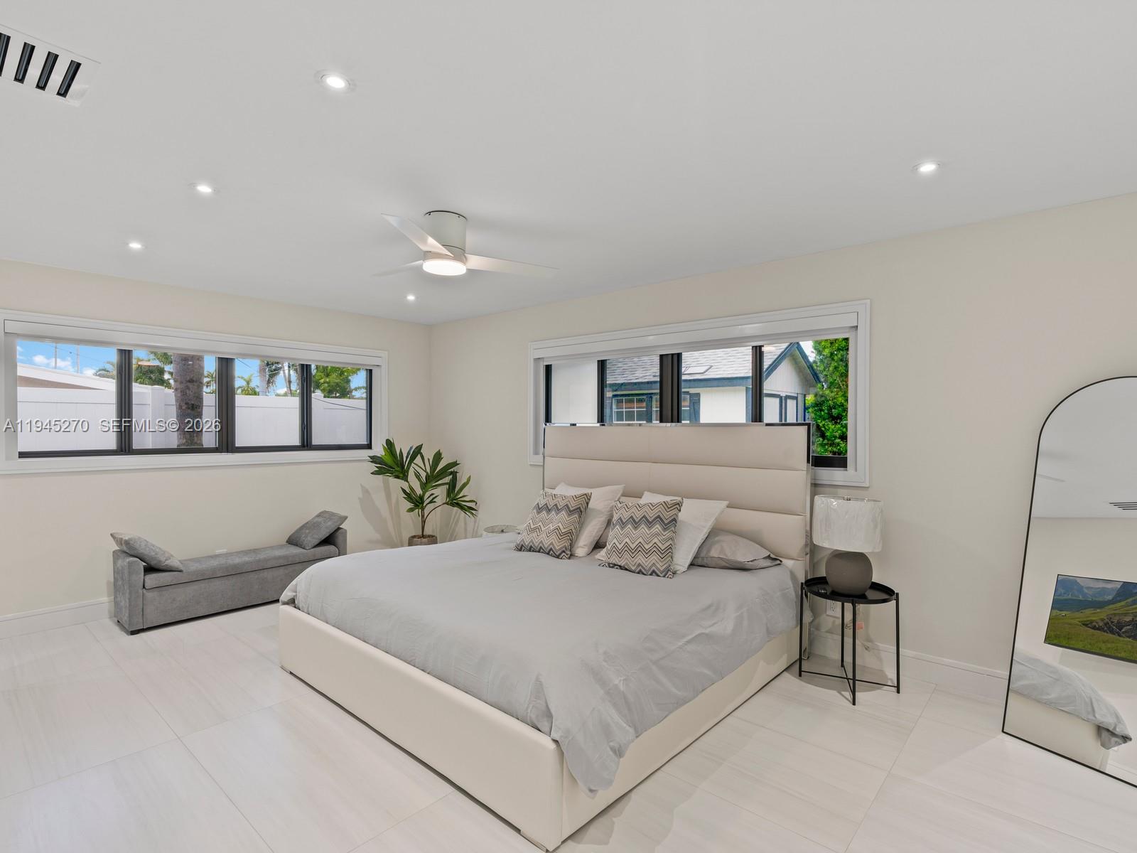 511 Southeast 14th Street Pompano Beach, FL 33060 - Photo 13 of 23 a bedroom with a large bed and a painting on the wall