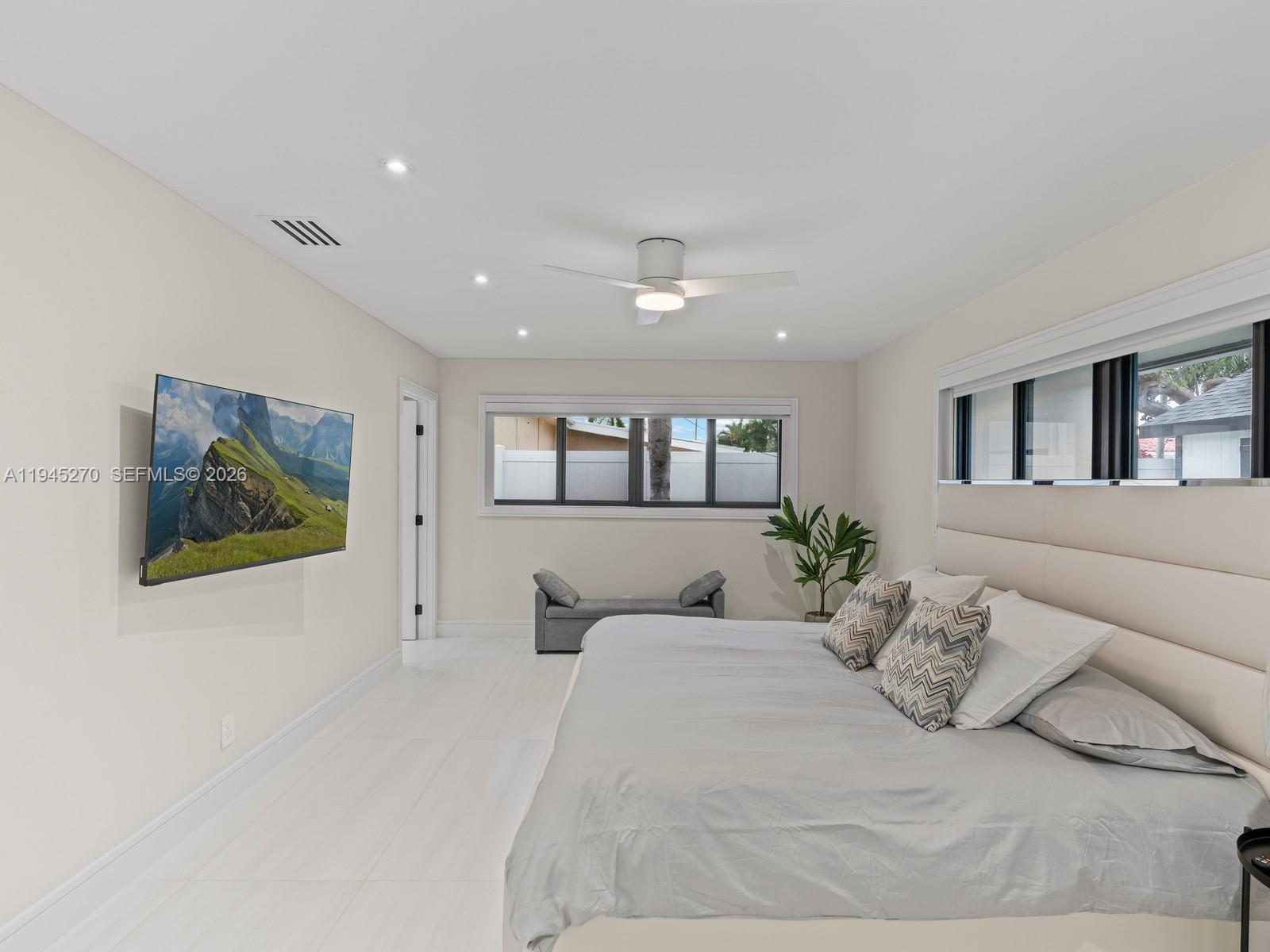 511 Southeast 14th Street Pompano Beach, FL 33060 - Photo 17 of 23 a bedroom with a large bed and a painting on the wall