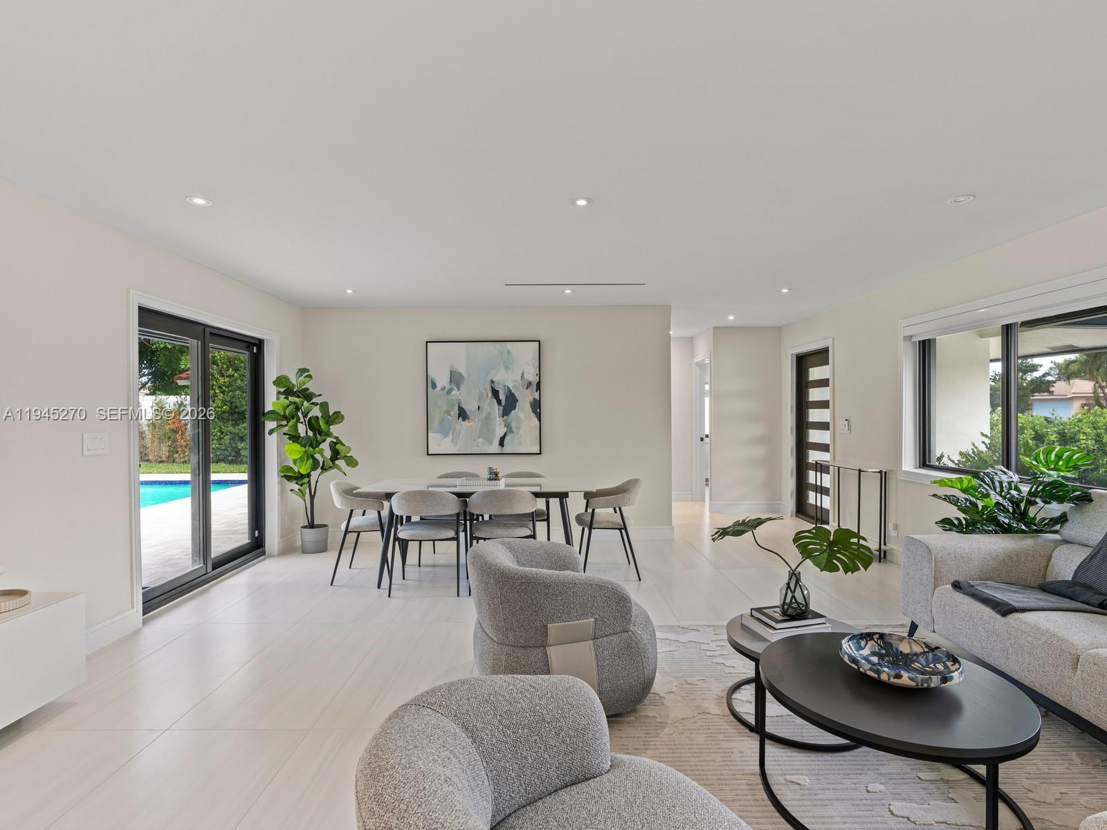 511 Southeast 14th Street Pompano Beach, FL 33060 - Photo 7 of 23 a living room with furniture potted plant and a large window