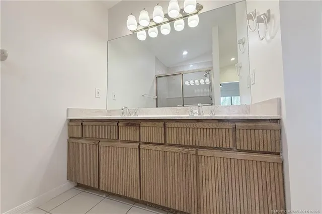 a bathroom with a sink vanity and a mirror