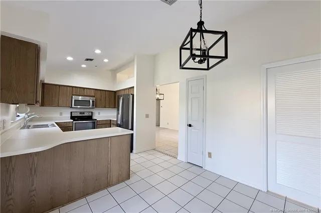 a kitchen with stainless steel appliances a sink stove and refrigerator