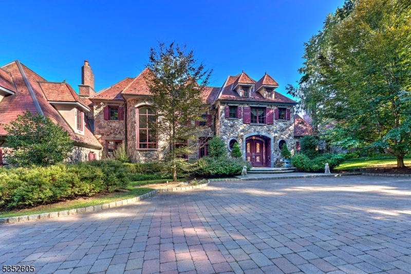 a front view of a house with a yard and a garage