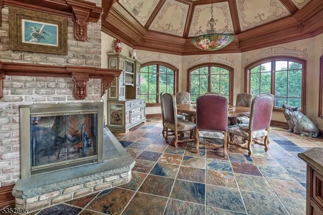 a dining room with furniture a fireplace and a chandelier