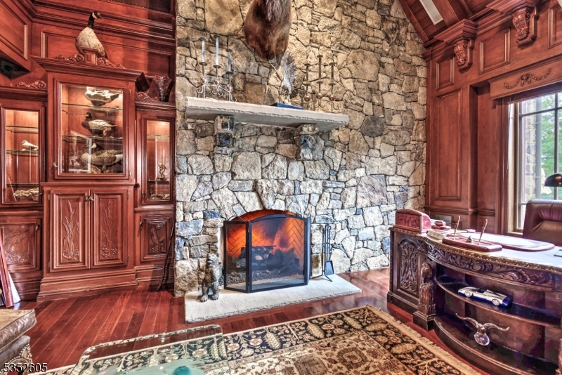 770 Pottersville Road Far Hills, NJ 07931 - Photo 15 of 29 a dining room with a wooden floor and a fireplace