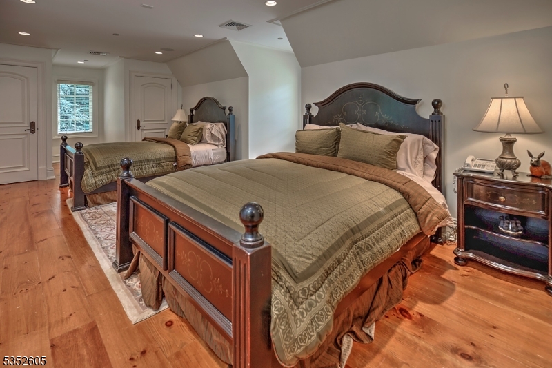 770 Pottersville Road Far Hills, NJ 07931 - Photo 20 of 29 a bedroom with a bed and a lamp