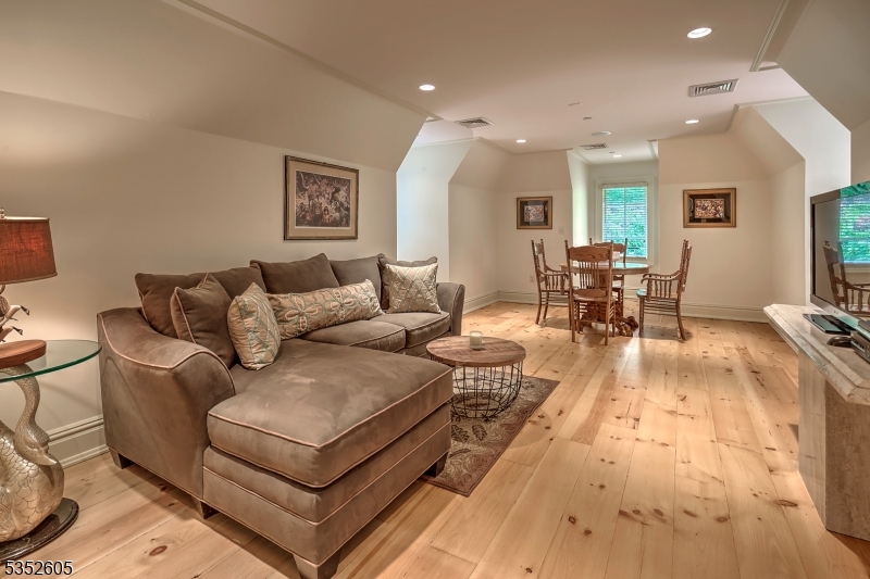 770 Pottersville Road Far Hills, NJ 07931 - Photo 21 of 29 a living room with furniture and a dining table with wooden floor
