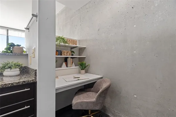 a walk in closet with view of bathroom
