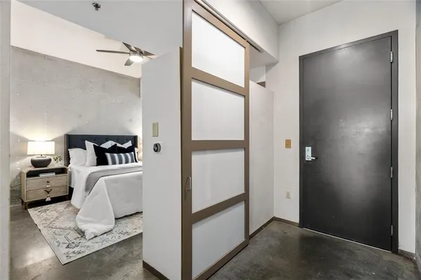 a bedroom with a large bed and a potted plant