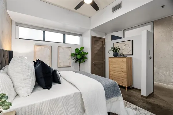 a bedroom with a bed and a painting on the wall