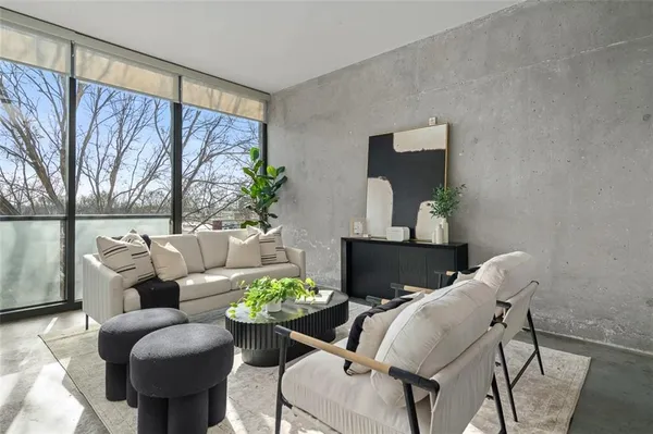 a living room with furniture and a potted plant