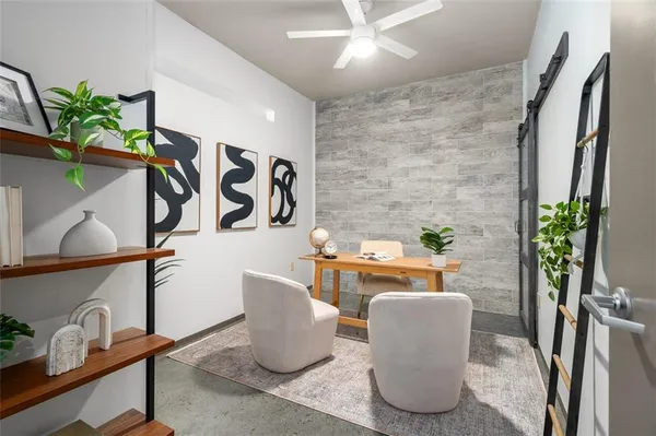 a living room with furniture and a potted plant