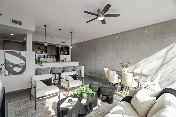 a living room with furniture and kitchen view