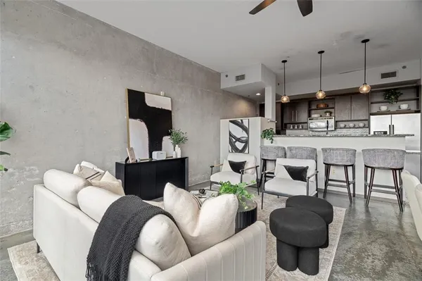 a kitchen with stainless steel appliances granite countertop a stove a refrigerator a kitchen island a sink and a table