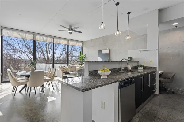 a kitchen with stainless steel appliances granite countertop a sink a stove and a refrigerator