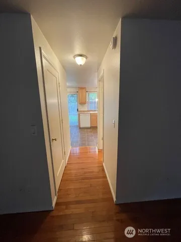 a view of a hallway with wooden floor