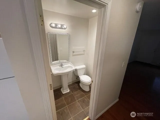 a bathroom with a sink a toilet a mirror and vanity