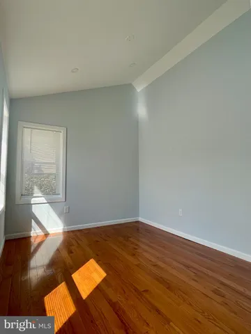 a view of wooden floor and windows in a room