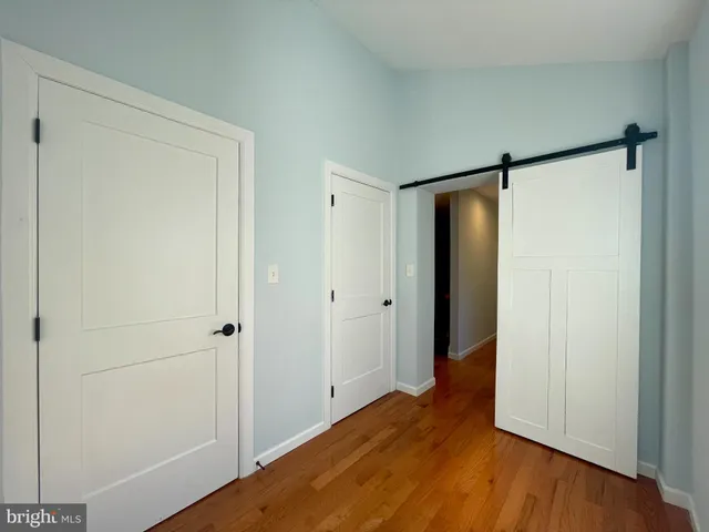a view of hallway with wooden floor