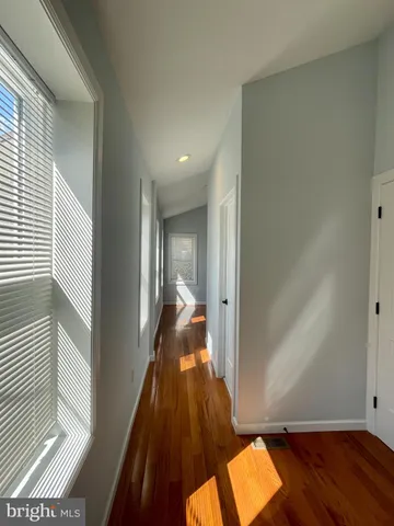 a view of hallway with wooden floor