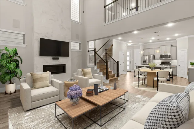 a living room with furniture a flat screen tv and a fireplace