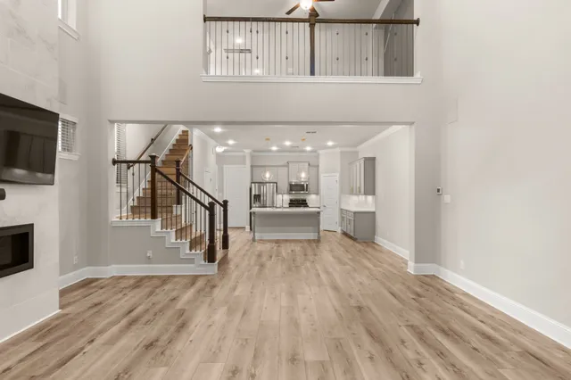 a view of a kitchen with wooden floor and a window