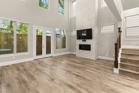 a view of a livingroom with wooden floor and a flat screen tv