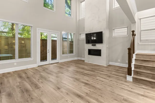 a view of a livingroom with wooden floor and a flat screen tv