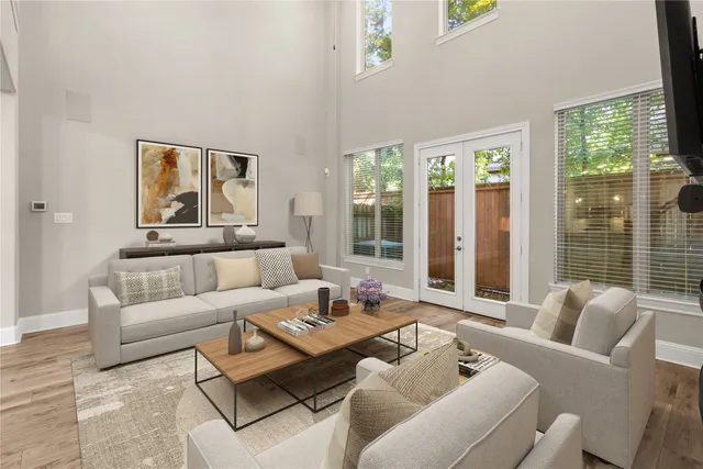a living room with furniture and large windows