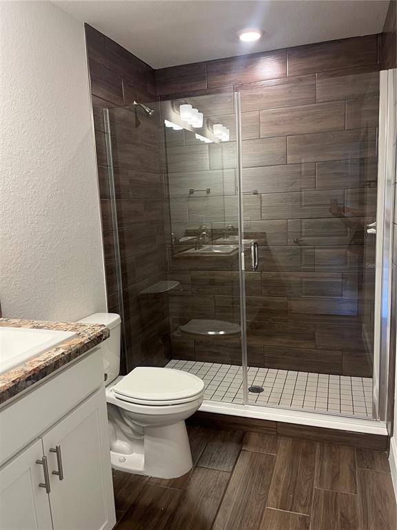 259 Bittern Loop Inverness, FL 34453 - Photo 11 of 18 a bathroom with a granite countertop toilet a sink and shower