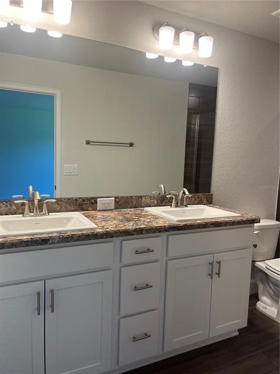 259 Bittern Loop Inverness, FL 34453 - Photo 10 of 18 a bathroom with double sink and a mirror