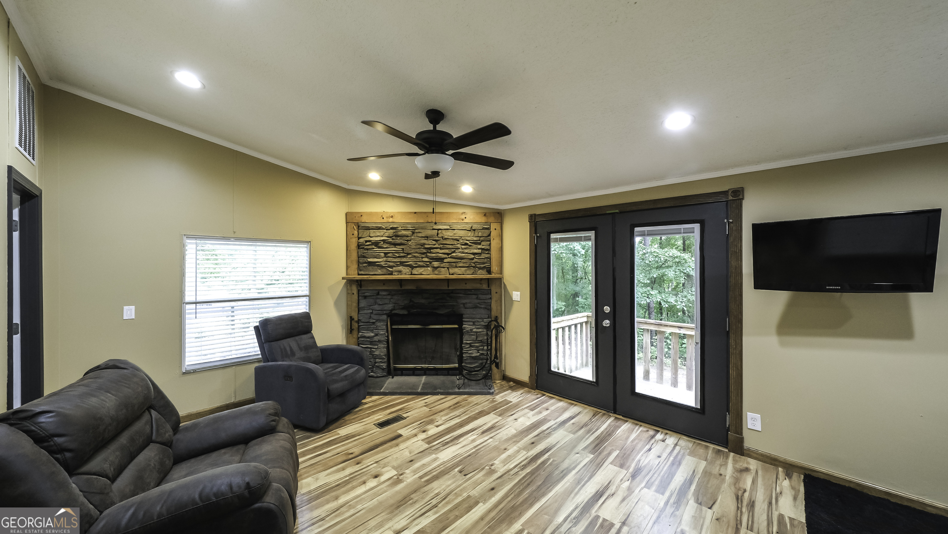 91 Holder Road Temple, GA 30179 - Photo 5 of 40 a living room with furniture a flat screen tv and a fireplace