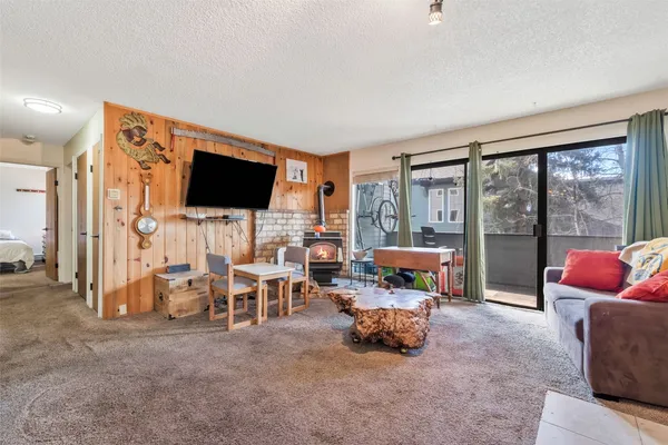 a living room with furniture and large windows