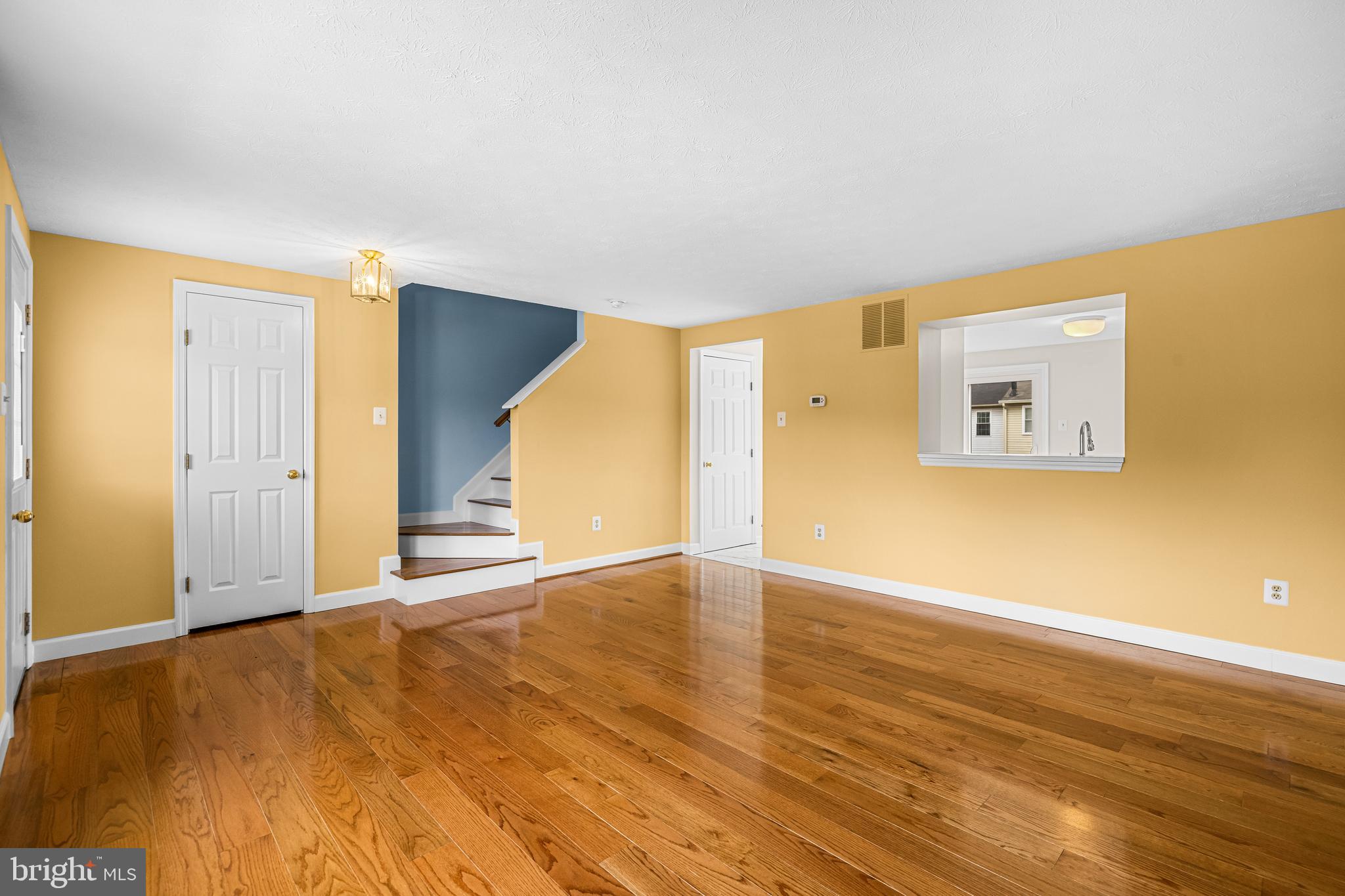 3790 Timahoe Circle Baltimore, MD 21236 - Photo 6 of 33 a view of an empty room with wooden floor and a window