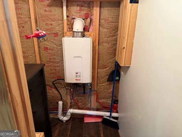 a room with a door and a microwave