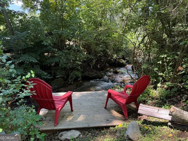 a view of a chairs and fire pit in the backyard