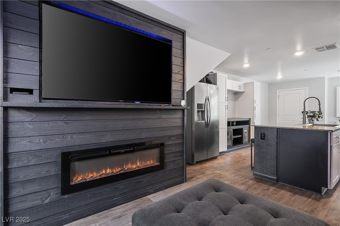 12236 Glass Desert Road, Unit 2 Las Vegas, NV 89183 - Photo 15 of 32 Living room featuring dark wood finished floors, recessed lighting, and a glass covered fireplace