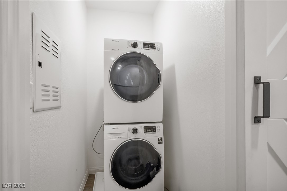 12236 Glass Desert Road, Unit 2 Las Vegas, NV 89183 - Photo 22 of 32 Washroom with stacked washer / drying machine and baseboards