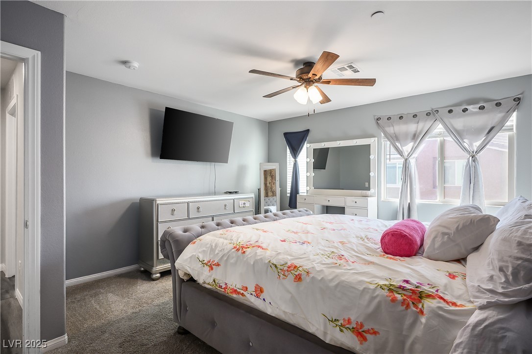 12236 Glass Desert Road, Unit 2 Las Vegas, NV 89183 - Photo 24 of 32 Carpeted bedroom featuring baseboards and a ceiling fan
