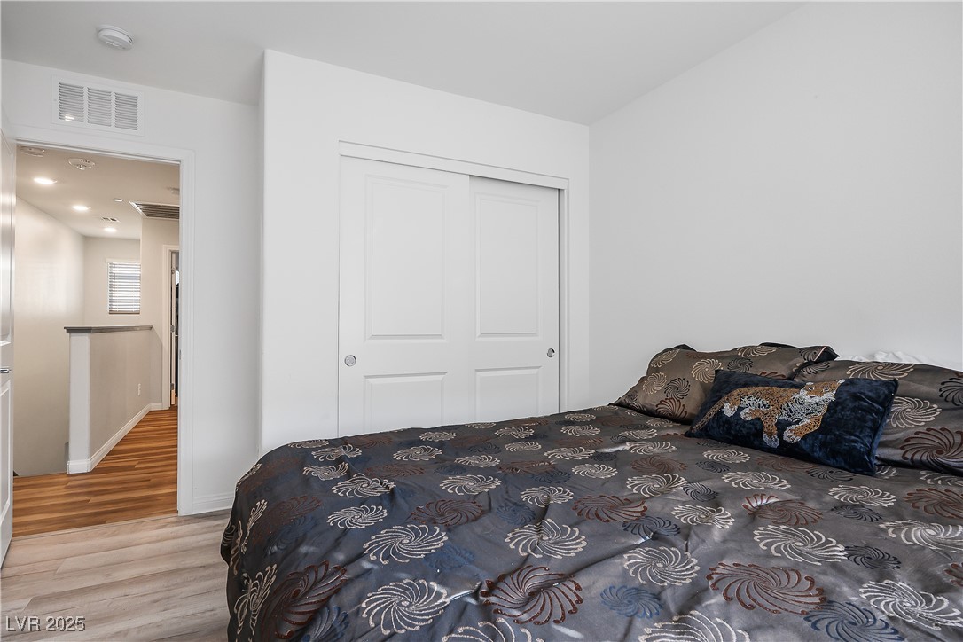 12236 Glass Desert Road, Unit 2 Las Vegas, NV 89183 - Photo 28 of 32 Bedroom featuring wood finished floors and a closet