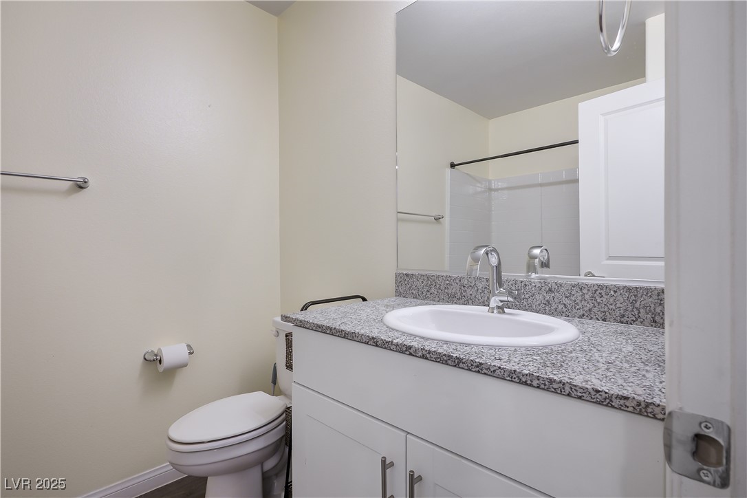 12236 Glass Desert Road, Unit 2 Las Vegas, NV 89183 - Photo 29 of 32 Bathroom with vanity and toilet