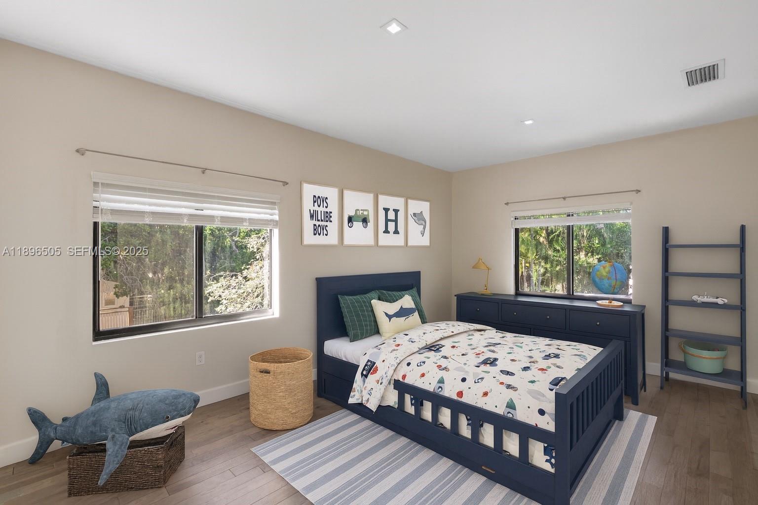 8501 Southwest 68th St Road Miami, FL 33143 - Photo 19 of 51 a bedroom with a large bed and a window