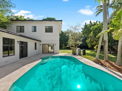 a dining room with furniture a livingroom view and wooden floor