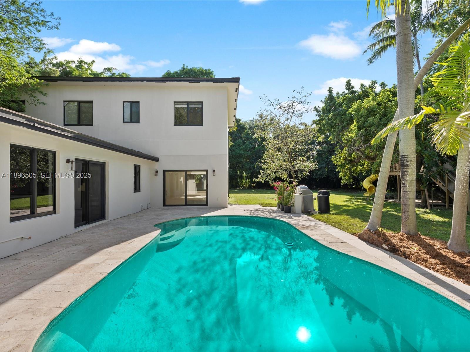 8501 Southwest 68th St Road Miami, FL 33143 - Photo 2 of 51 a front view of house with yard and green space