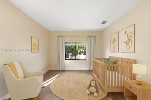 a bedroom with a large bed and a potted plant