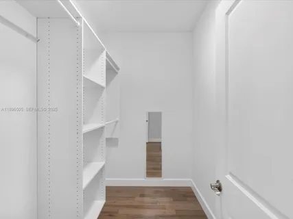 a bathroom with a granite countertop sink a toilet and a mirror